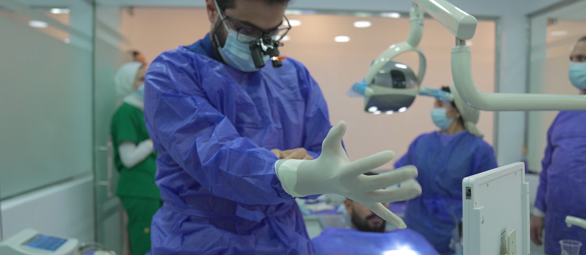 Dental surgeon preparing for implant surgery in Cairo clinic.